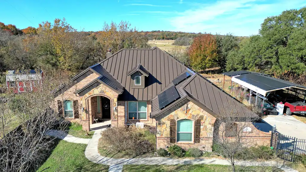 A new standing-seam metal roof on a brick home in Springtown, TX