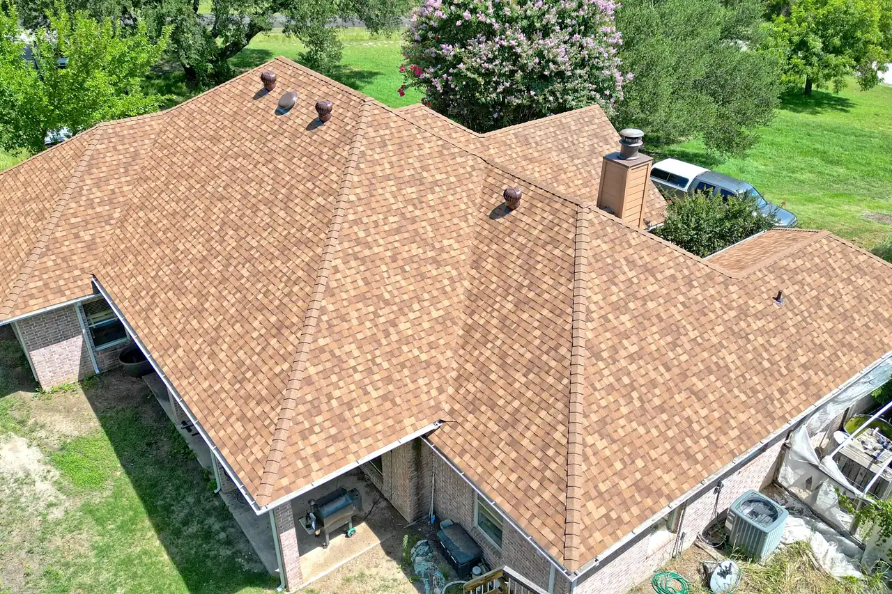 A finished shingle roof photographed from above, ridge to eave