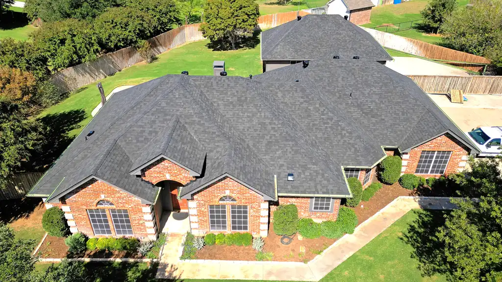 A new architectural shingle roof on a brick home near Azle, TX